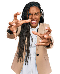 Wall Mural - African american woman wearing business jacket shouting frustrated with rage, hands trying to strangle, yelling mad