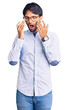 © Krakenimages.com - Handsome hispanic man wearing business shirt and glasses rubbing eyes for fatigue and headache, sleepy and tired expression. vision problem