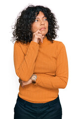 Poster - Young hispanic woman wearing casual clothes with hand on chin thinking about question, pensive expression. smiling with thoughtful face. doubt concept.