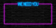 We need you. Neon sign. Brick wall at night with the text 