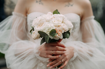 Wall Mural - The image features a person holding a bouquet of white flowers 6847.