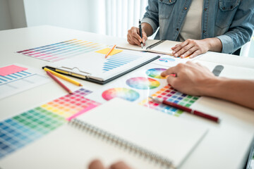 Poster - Team of creative graphic designer working on color swatch samples chart for selection coloring in inspiration to create new collection at workplace