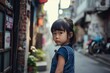Little Asian girl in the streets of the old town in China.