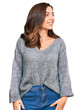 © Krakenimages.com - Young brunette woman wearing casual winter sweater looking away to side with smile on face, natural expression. laughing confident.