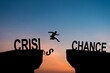 © Philip - Mindset concept, Silhouette man jumping from crisis to chance wording on cliff with cloud sky.