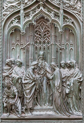 Wall Mural - MILAN, ITALY - SEPTEMBER 16, 2024: The detail from main bronze gate of the Cathedral - Spouse of St. Joseph and Virgin Mary -  by Ludovico Pogliaghi (1906).