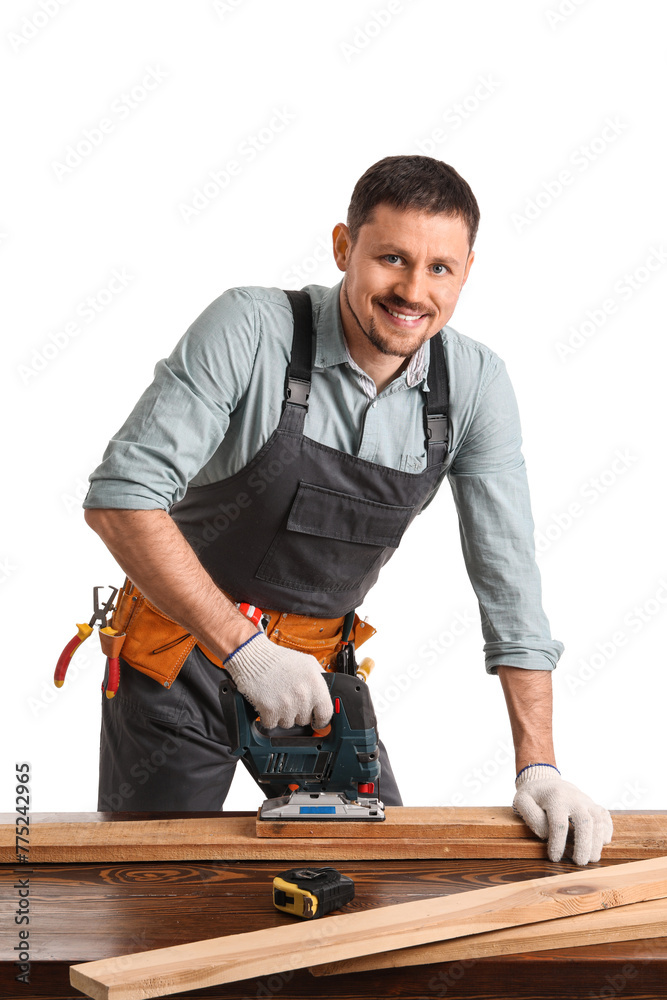 Male carpenter sawing wooden plank at table on white background