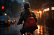 A beautiful young adult of Asianformal woman riding her bicycle to work, a backside portrait of a woman commuting on a bicycle on a rainy day in an urban street at sunset 