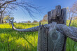 Close-up shot of a rustic fence with a rope on a rural field