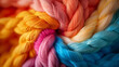 Multiple colorful yarns braided together.