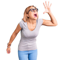 Sticker - Young blonde woman wearing casual clothes shouting and screaming loud to side with hand on mouth. communication concept.