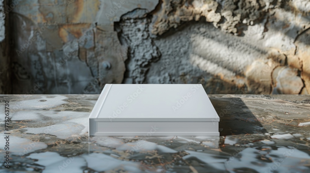 A white book sitting on top of a table. Ideal for educational or office concepts