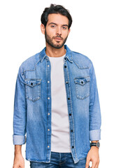 Poster - Young hispanic man wearing casual clothes relaxed with serious expression on face. simple and natural looking at the camera.