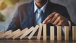 © Marko - Businessman hand protect and stop wooden house from domino falling wooden bar for risk management and analysis of real estate concept for business