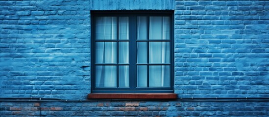 Poster - A detailed view of a window on a tall blue brick building with a beautiful architectural design