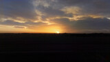 Fototapeta Psy - Zachód słońca przysłonięty piaskiem z pustyni, żwirownia na polach Biadacza, Opolszczyzna Polska, widok z lotu ptaka