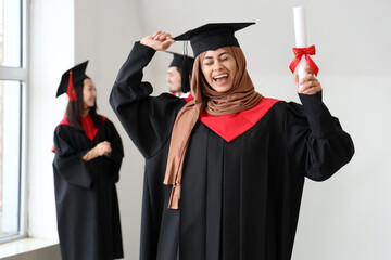 Sticker - Muslim female graduate student with diploma in light room