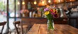 A vase of flowers on a restaurant table