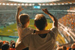 A man and a child are watching a soccer game