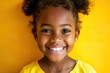The smile of an African American elementary school girl. Portrait of smiling kid with white teeth