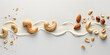 Swirls of cream with whole and split cashew nuts and ground cashews on a white surface. Creative food styling concept with copy space for design and print.