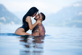 Fototapeta Panele - Summer sexy couples. Romantic couple in sea water. Beautiful young couple in love on the lake. Sexy couple kissing by the sea. Dream vacation. Embrace and kiss in the water. Romantic beach paradise.