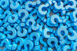 Stack of Blue Question Marks on Table