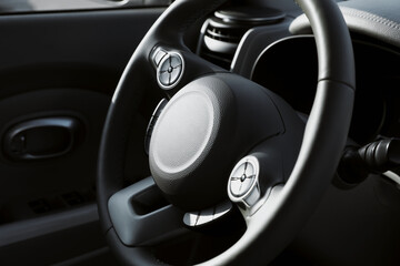 Wall Mural - Black steering wheel inside of modern car, closeup