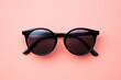 Black Retro Round Sunglasses Isolated on Pink Background. Stylish Unisex Accessory for Summer. UV Protection. Hipster Fashion. 3D Rendering Illustration for Trendy Eyewear Lovers