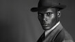 © Justlight - In a black and white portrait a striking black man exudes confidence and suave charm his tailored suit and fedora hat giving off vibes of old cinema. His chiseled features and captivating .