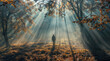 Man in the autumn forest with sunbeams and rays of light