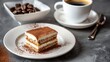 A slice of tiramisu alongside a small espresso cup and saucer, emphasizing the traditional pairing 