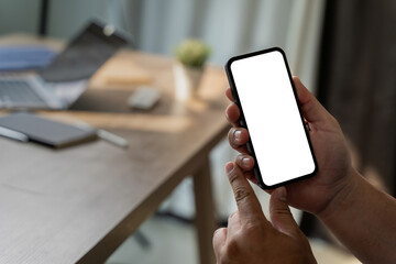 Poster - Top view Mockup image hand using a smartphone man Holding Cell Phone With Blank Screen