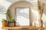 Fototapeta Natura - A simple wooden frame on an arched shelf in the wall surrounded by natural elements like plants and artwork