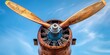 Antique wooden airplane propeller, close-up, clear blue sky background, dawn of aviation history 