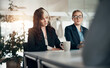 © Flamingo Images - Focused businesswoman writing notes during an office meeting in a boardroom