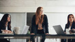 © Flamingo Images - Young red head executive listening to her team during an office meeting