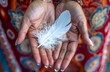 © Salander Studio - womans hands holding a white feather - symbol of peace