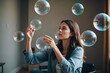 young woman playing indoors with big bubbles conceptual and dreamy