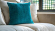Modern living room interior design of a farmhouse. Close-up of a beige sofa against a grid window, adorned with a turquoise pillow.
