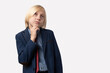 © somemeans - Thoughtful young businessman with short blond hair and blue jacket, looking up, thinking about something while standing against white background.