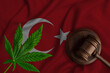 Cannabis leaf and judge gavel on the national flag of Turkey. Concept of legalization of marijuana