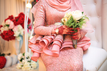 Wall Mural - Wedding bride holding bouquet of flowers. Close up and selective focus.