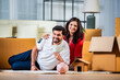 Indian young couple and saving concept with piggy bank and home moving with boxes