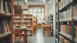 Blurred library interior with bookshelves and chairs