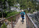 Fototapeta Miasto - Woman walking on the bridge at Eagle Lake trail. South Lake Tahoe. California.