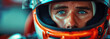 portrait of a man Formula One racer pilot in helmet in a racing car F1 driving on track at a race competition