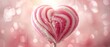 Lollipop shaped like a heart, made from pink and vanilla candy