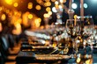 A close-up view of an elegant dinner table setting with clear wine glasses, cutlery, and a warm, bokeh light background creating a luxurious atmosphere.