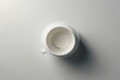 A white cup with a white lid is sitting on a white table